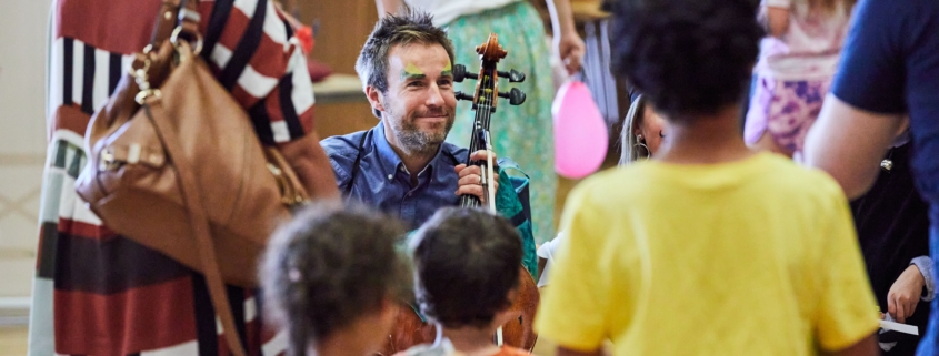 Musician talking with a group of children