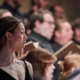 Profil;e shot of a singer performing with the Festival Voices.