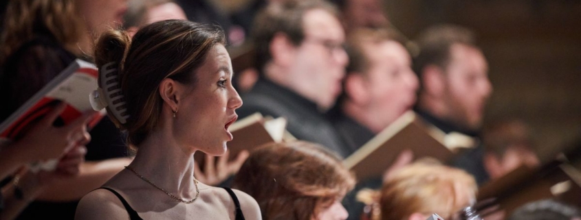 Profil;e shot of a singer performing with the Festival Voices.