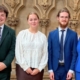 Four young singers, wearing smart clothing, stood together for a photo in Southwell Minster.